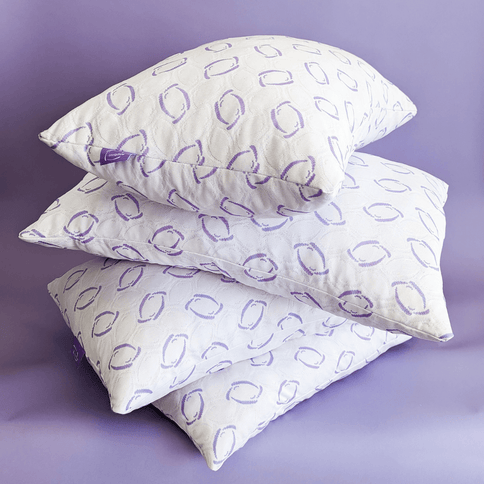 Three OmniPillows with a purple pattern on a purple background

